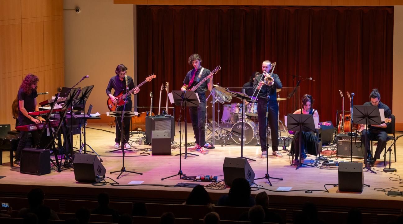Members of the Rock Collegium student ensemble perform together on stage at Sonoma State University's Green Music Center.