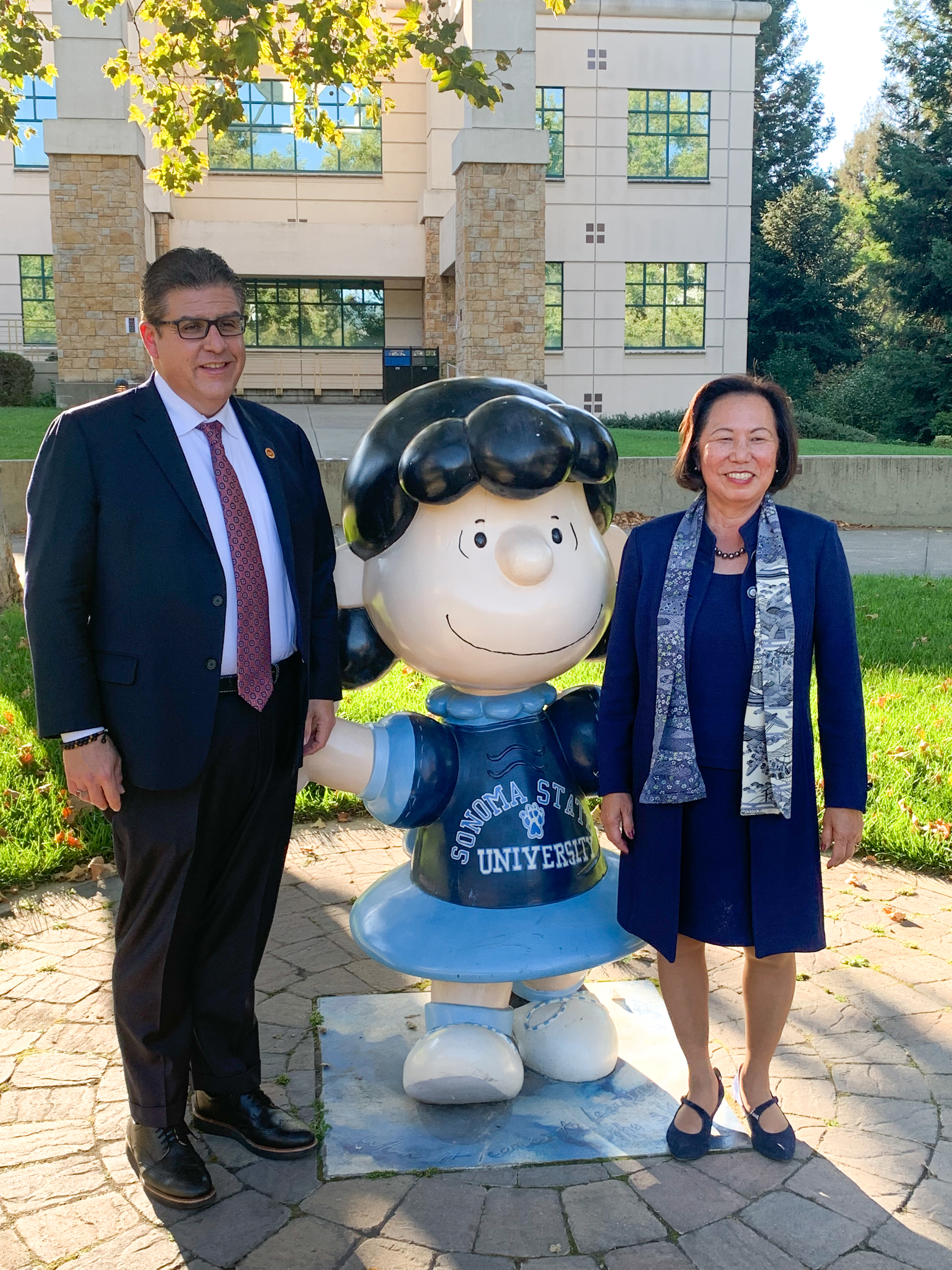 Chancellor Castro poses for photo with President Sakaki at the Lucy statue