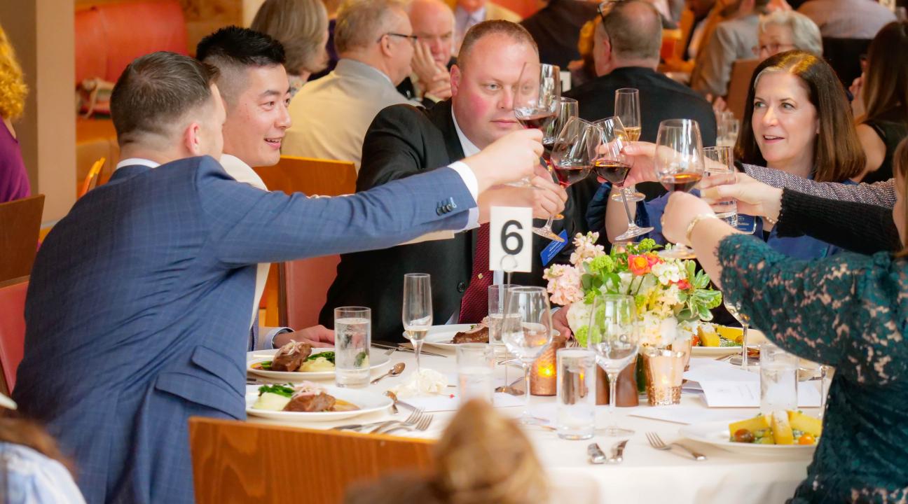 Attendees toast at the dinner.