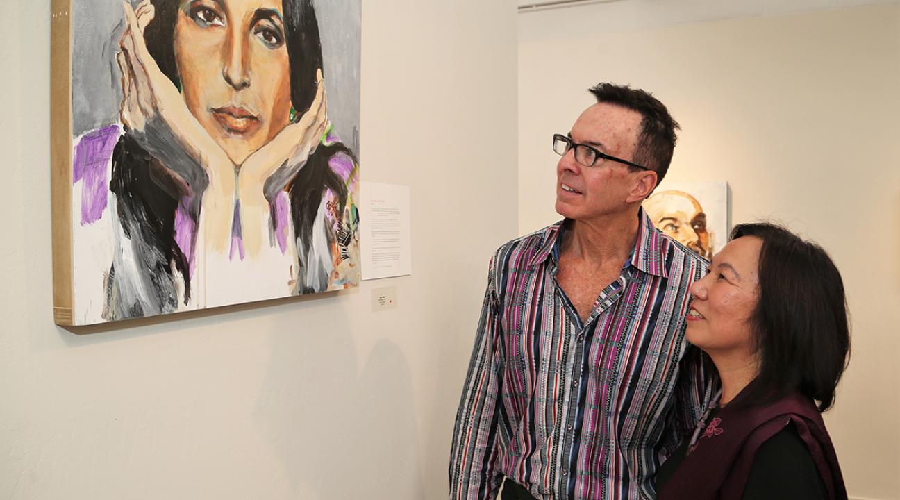 SSU President Judy Sakaki and FIGR Tribal Chairman Greg Sarris admire a self-portrait by Joan Baez