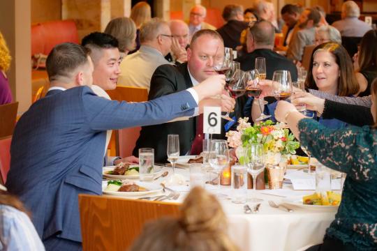 Attendees toast at the dinner.