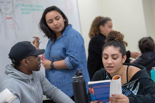 Sonoma State students collaborate on a project in a classroom.
