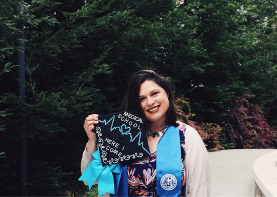 Emma Towslee showing off her graduation cap