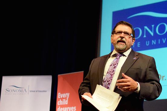carlos ayala speaking at the education summit