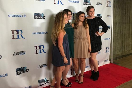 students posing for pictures at the red carpet 