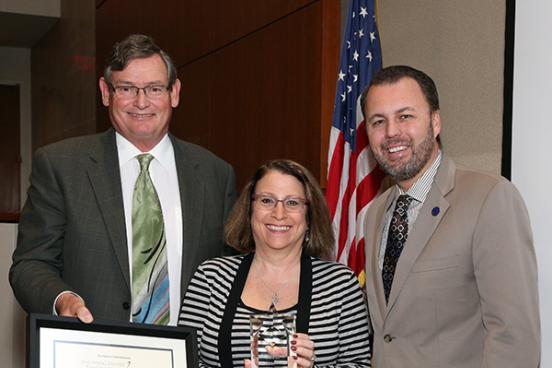 CSU Chancellor Timothy White and Chair of the Board of Trustees, Lou Monville present SSU physics and astronomy professor Lynn Cominsky with the Wang Family Excellence Award