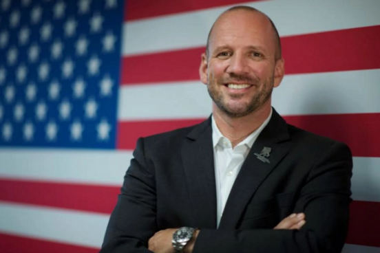 dan nevins in front of american flag