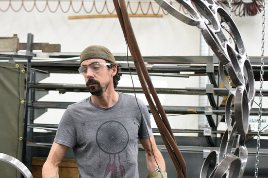 Andrew Scanlon works on "Holons," a steel sculpture on display as part of Commence: Sculpture projects 2015