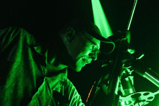 Green laser being shot at the moon