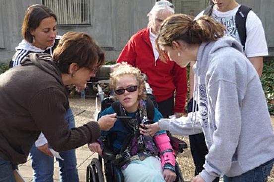 Jazlyn LeClair with the kicking-and-throwing machine developed by Engineering Science students jazlyn in wheelchair