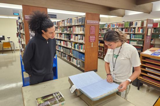 SSU student researchers Jeremy Medrano and Juliana Chand looking through county records