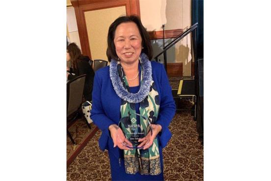 President Judy Sakaki holding her NASPA award