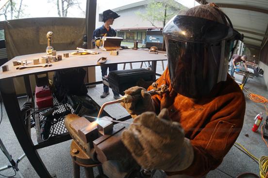 student welding 