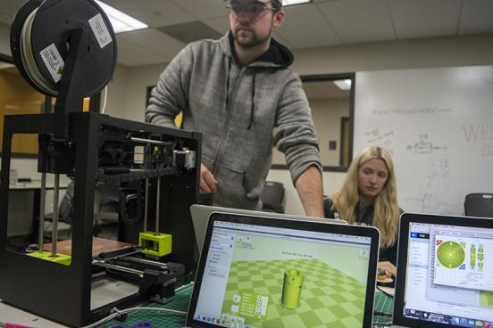 Students using 3D printer in Makerspace