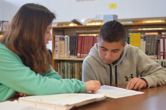MEAP advisor Angelica Arguelles ​works with Rancho Cotate High School student Luis Maldonado on picking a subject for a speech and debate class.