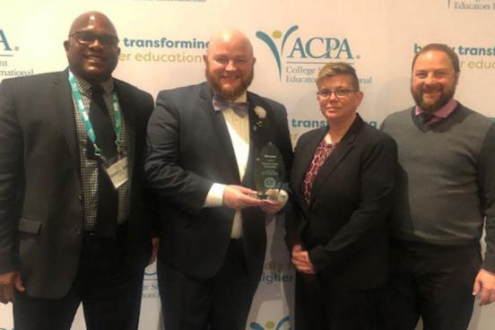 (left to right) Student Affairs staff Gerald Jones, Ryan Jasen Henne, Stacey Murray and Dean Kennedy accept an award recognizing SSU as one of the "Most Promising Paces to Work in Student Affairs" at the 2019 ACPA Awards.