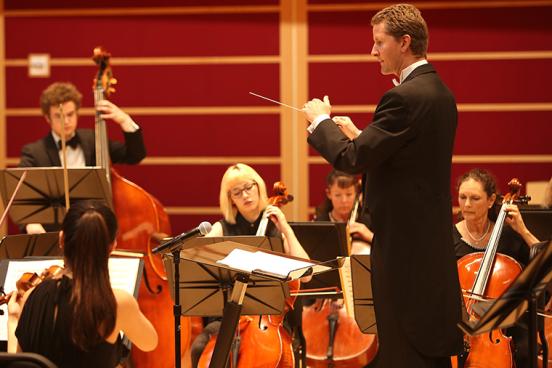 conductor leading orchestra