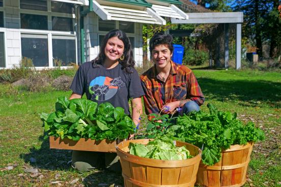 Sophia Pruden and Evangelina Austin pose with vegetables
