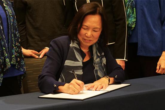 President Judy K. Sakaki signs President's Climate Commitment 