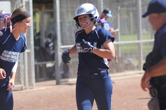 softball players celebrating home run