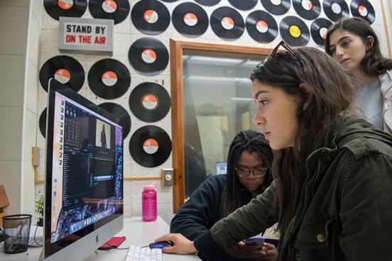Students in Studio Blue edit videos in class // Photo by Alison Wagner students editing in class