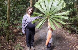 Associate Professor Lisa Patrick Bentley and her son, Allen, showing off a big tropical leaf in Aust