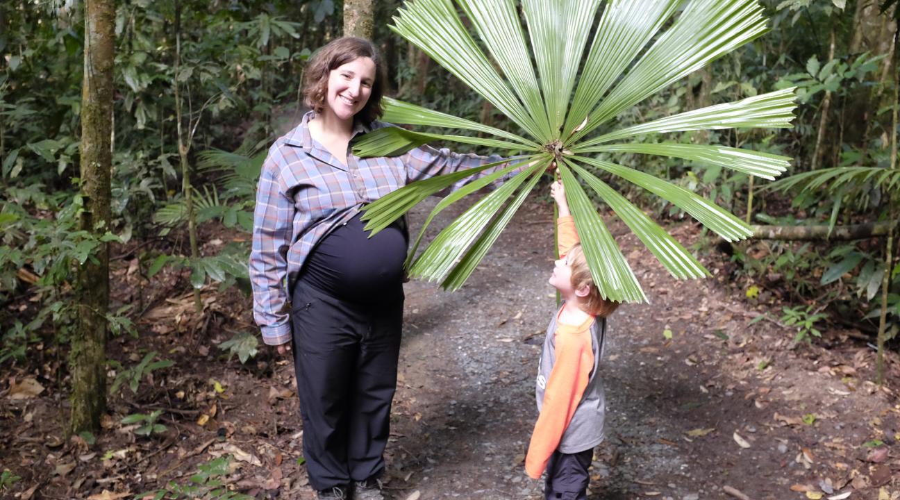 Associate Professor Lisa Patrick Bentley and her son, Allen, showing off a big tropical leaf in Australia.