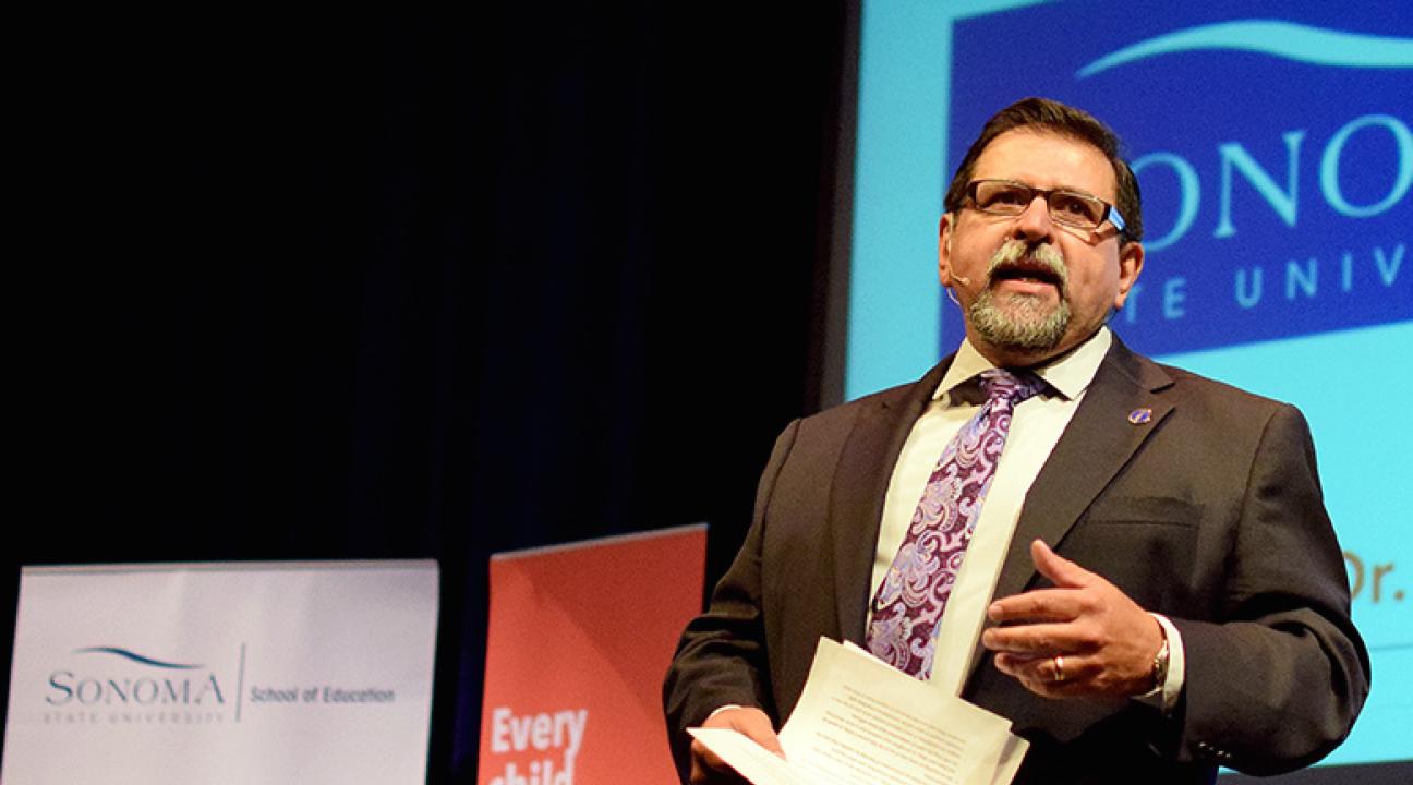 carlos ayala speaking at the education summit
