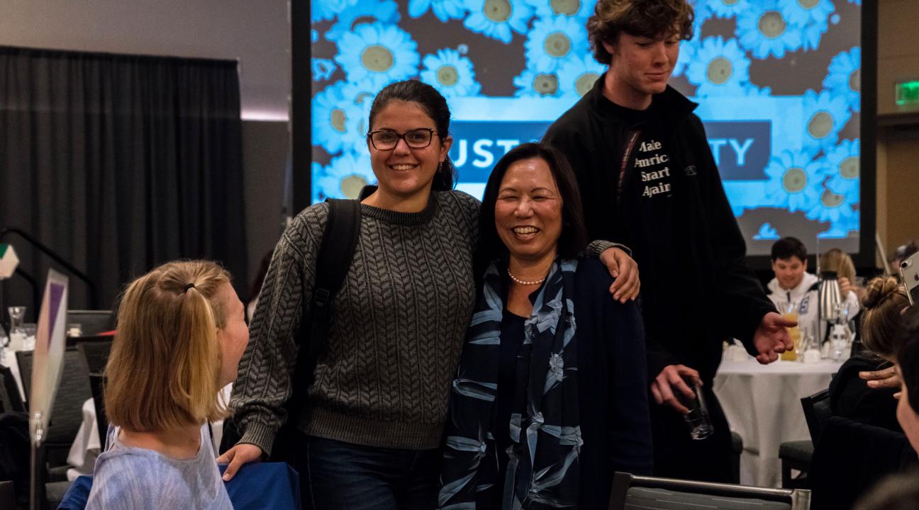 President Sakaki poses with student at the "Presidents Climate Leadership Commitment"