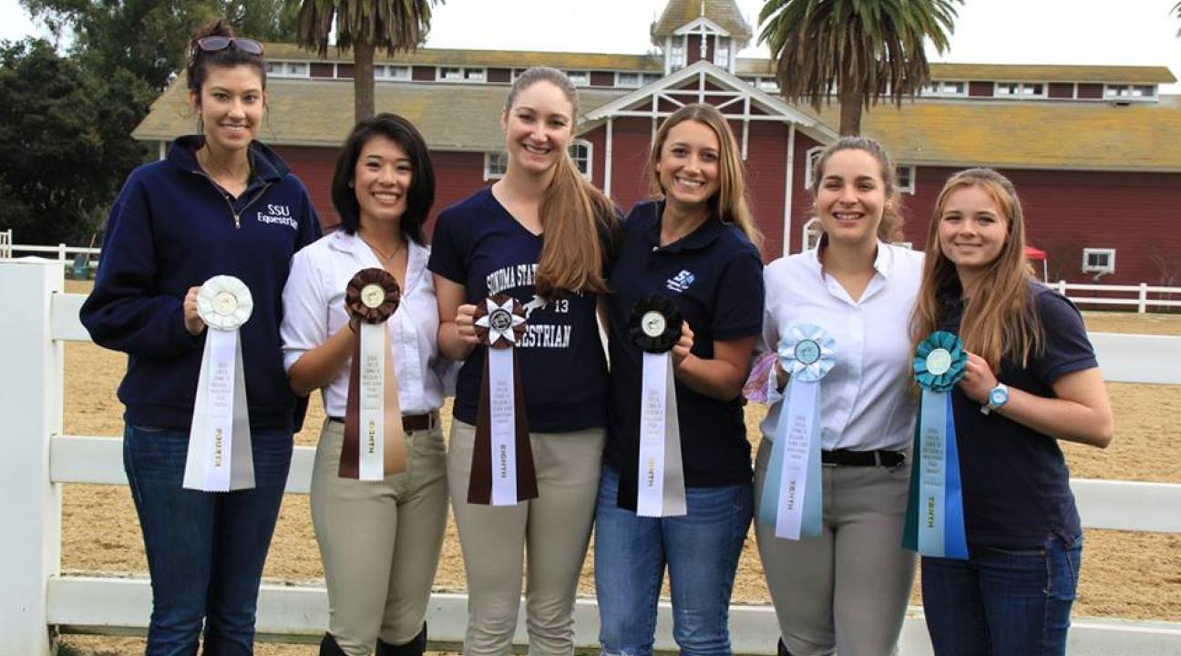 Equestrian team members proudly display their awards. 