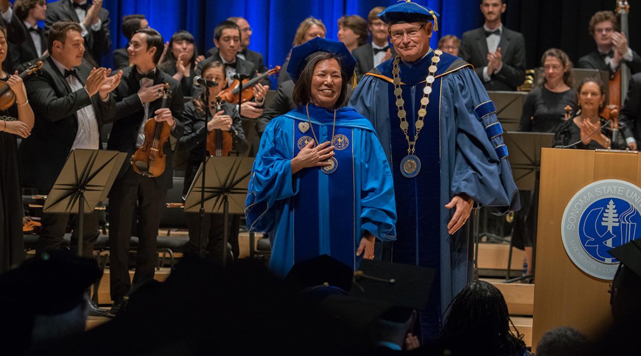 judy sakaki in ceremony with chancellor timothy white