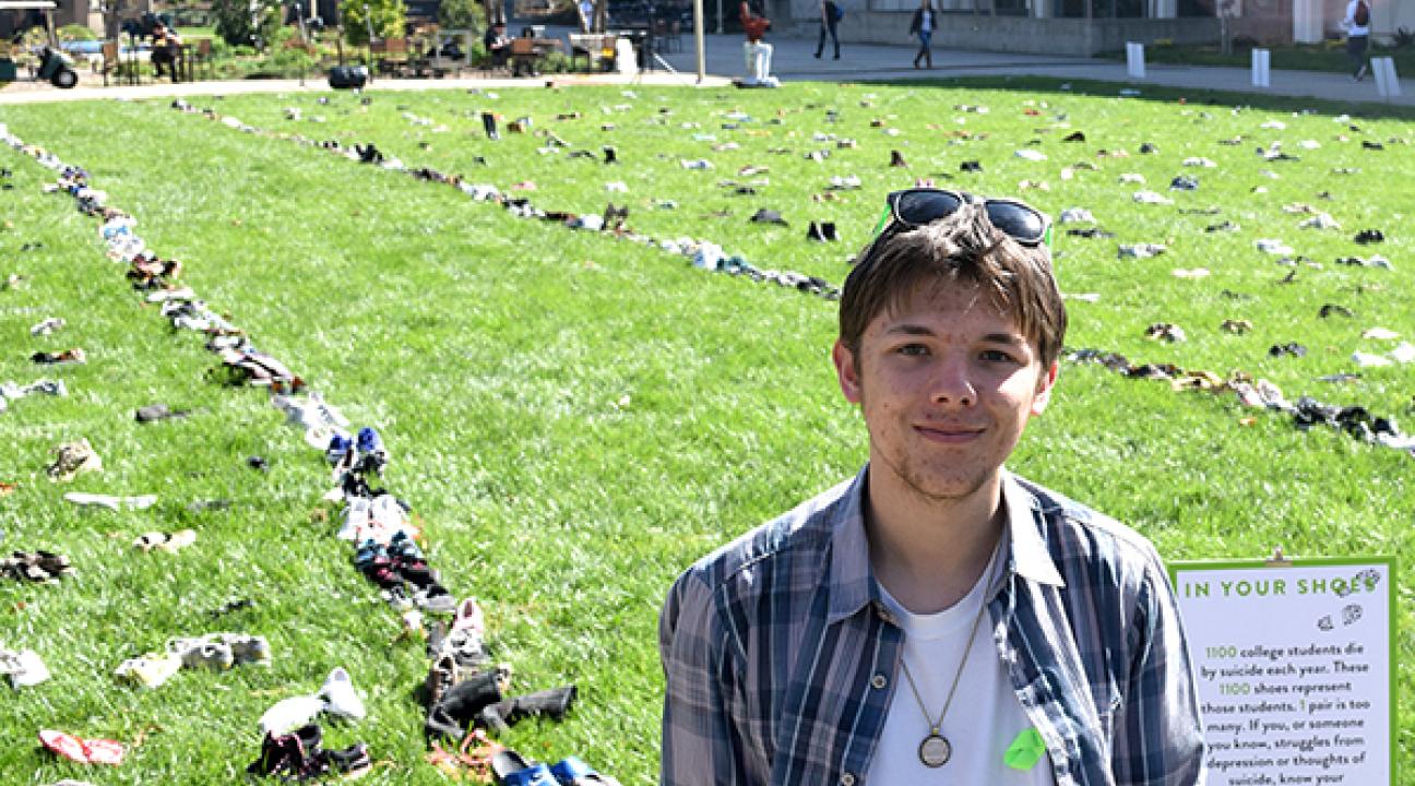 Ben Teurlay next to his art piece 