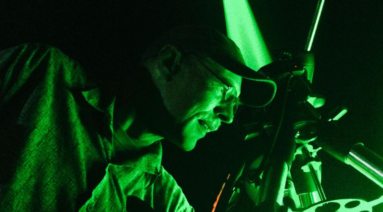 Green laser being shot at the moon