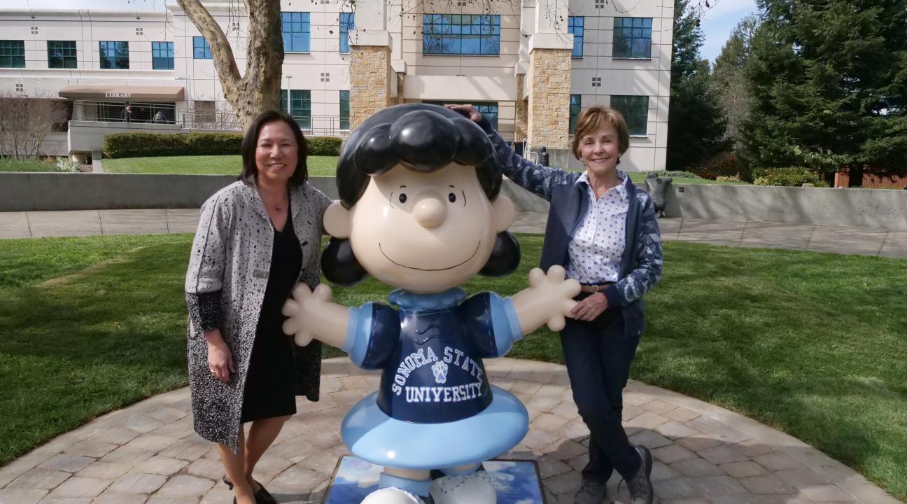 President Judy K. Sakaki and Jeanie Schulz with SSU's new Lucy statue