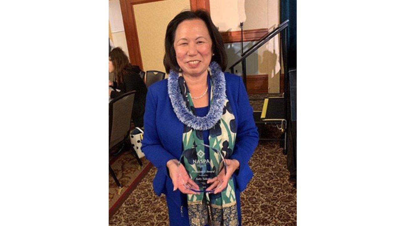 President Judy Sakaki holding her NASPA award