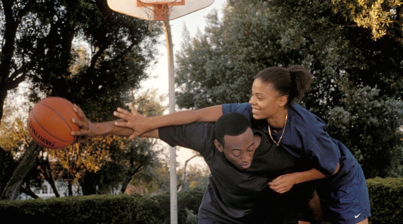 Still from Gina Prince-Bythewood's film "Love & Basketball" (2000). a couple playing basketball.