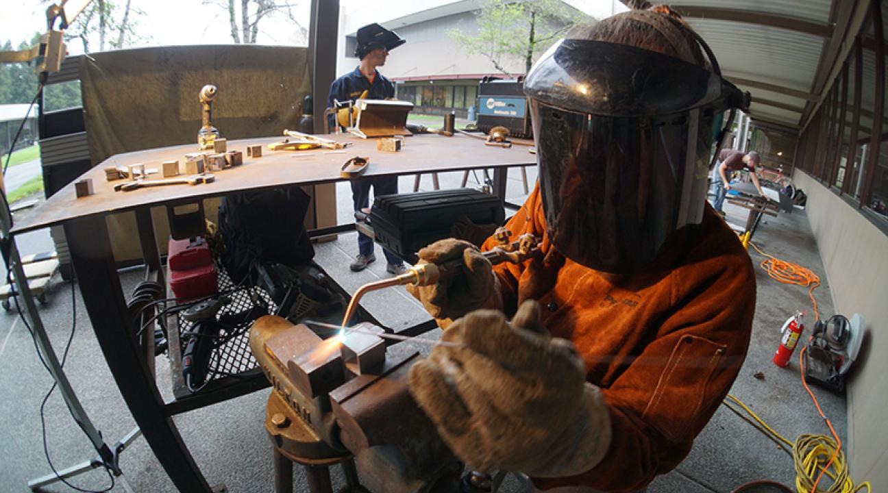 student welding 