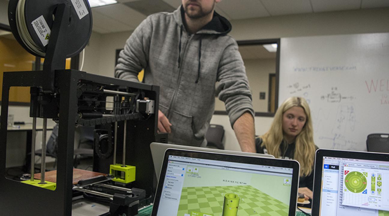 Students using 3D printer in Makerspace