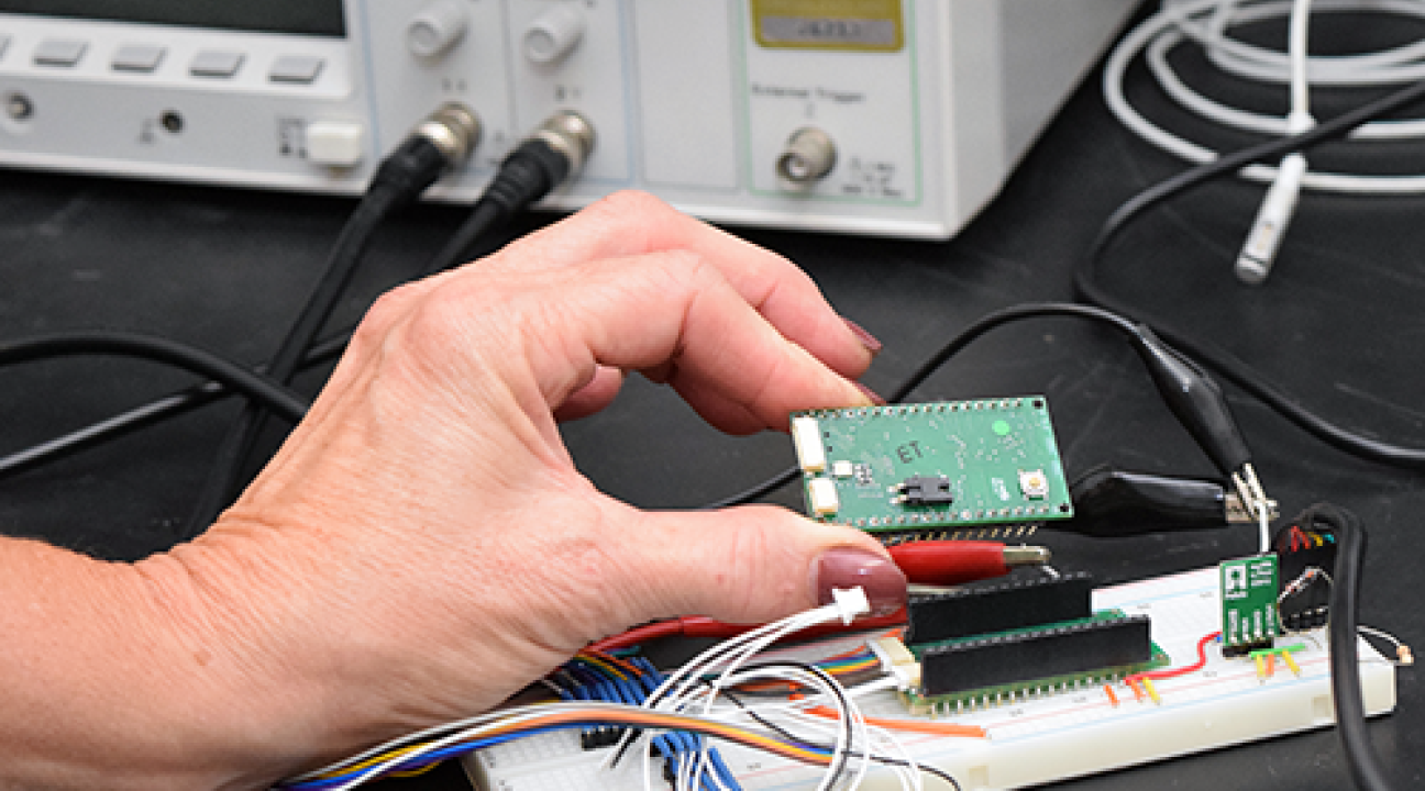 hand holding microchip