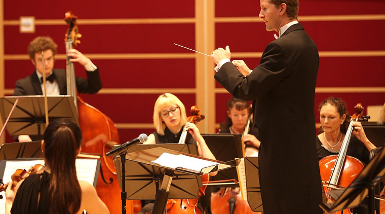 conductor leading orchestra