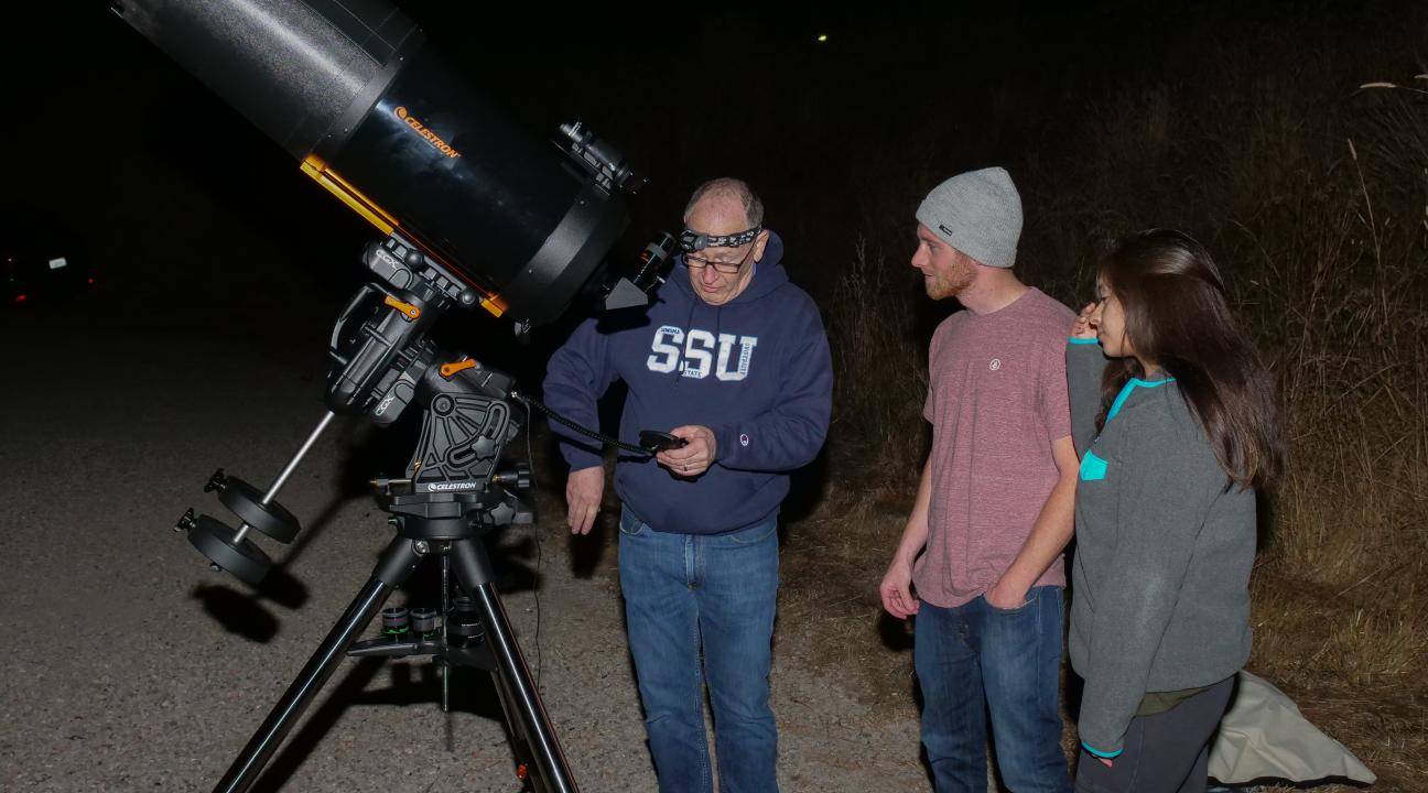 volunteer with telescope