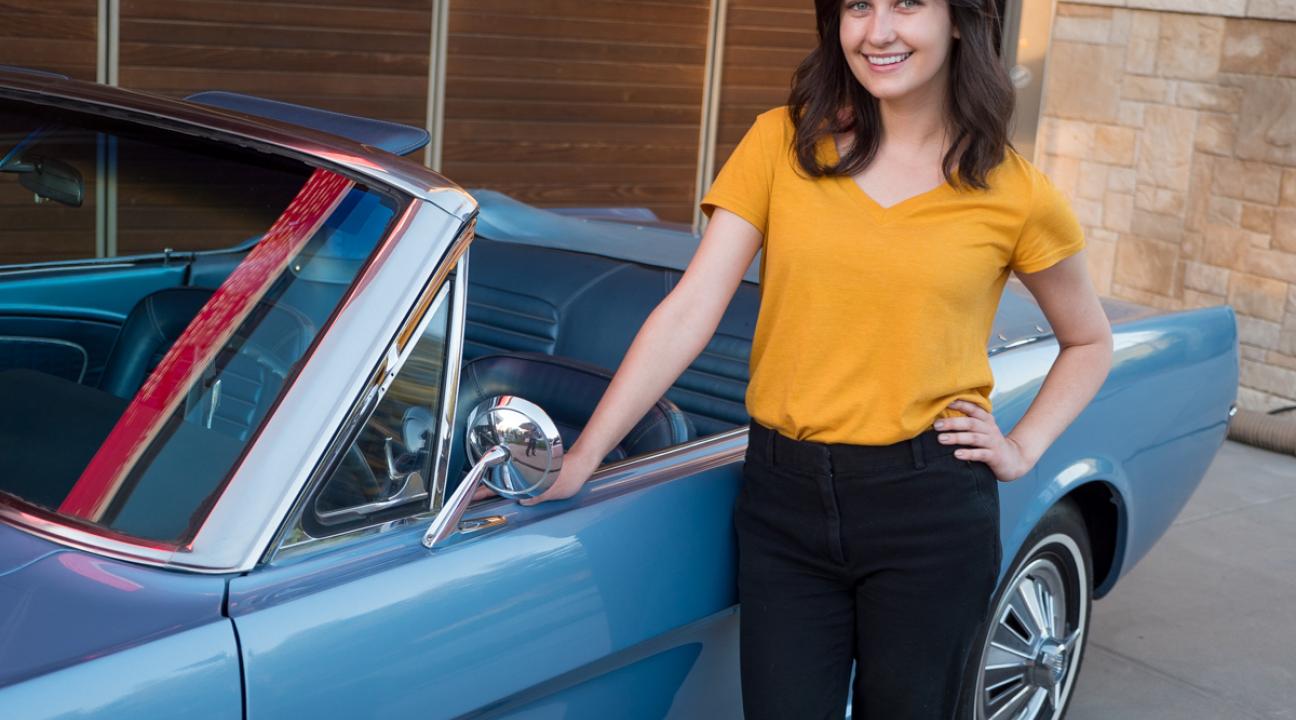 woman with classic Mustang