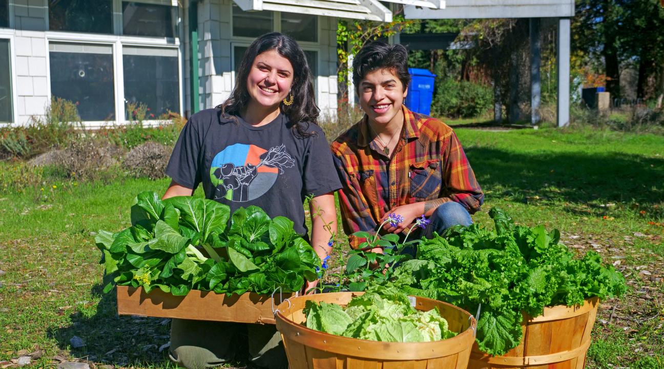 Sophia Pruden and Evangelina Austin pose with vegetables