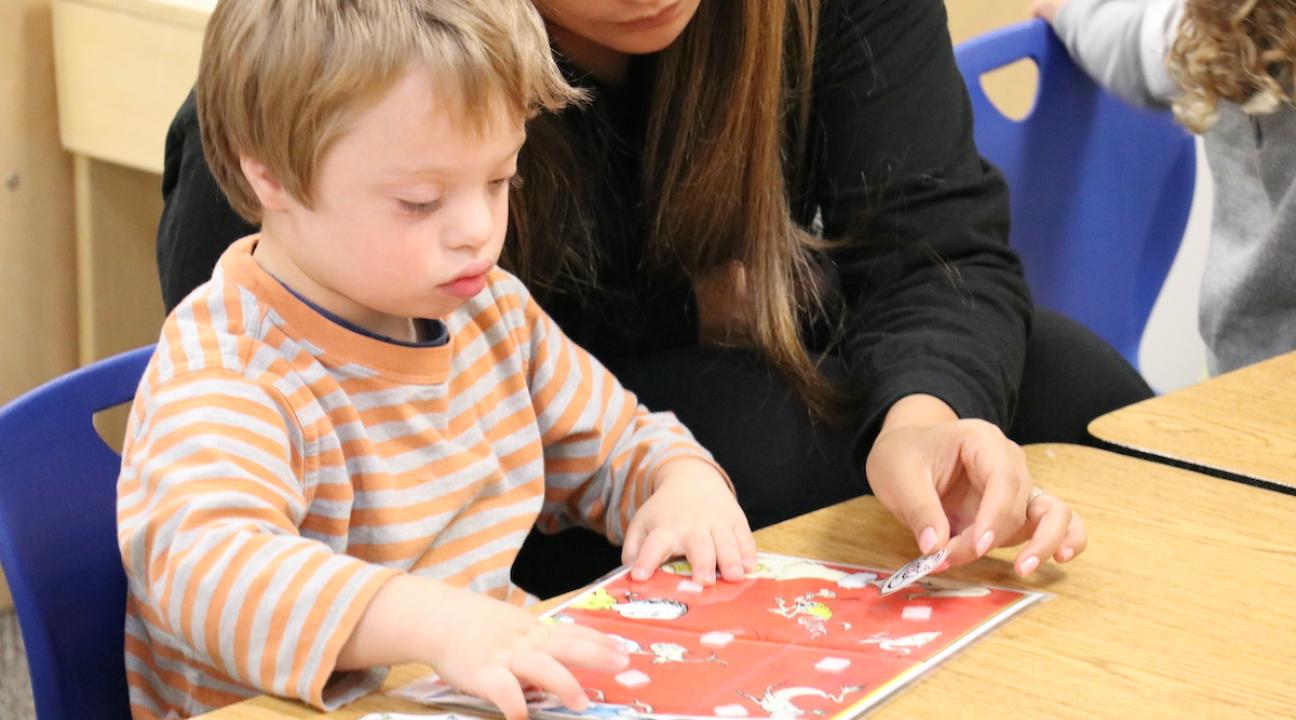 Child and teacher with art