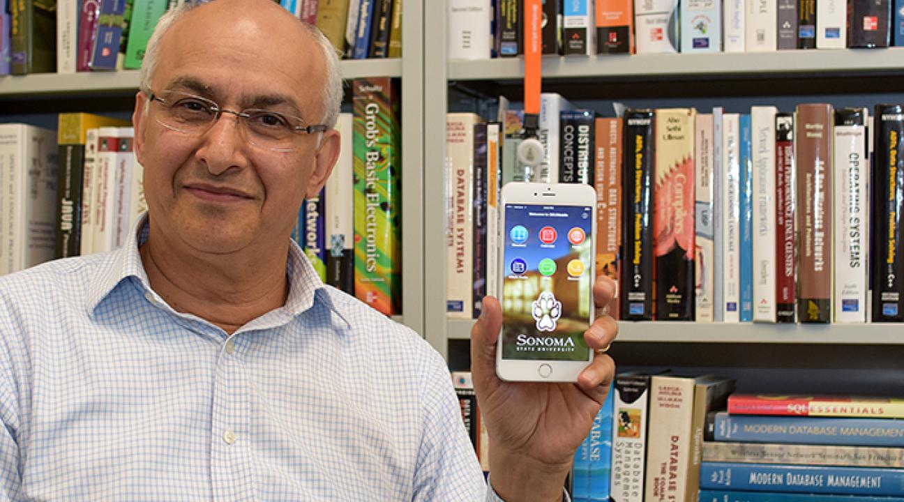 SSU computer science professor Ali Kooshesh holds up an iPhone showing SSU's redesigned mobile app.