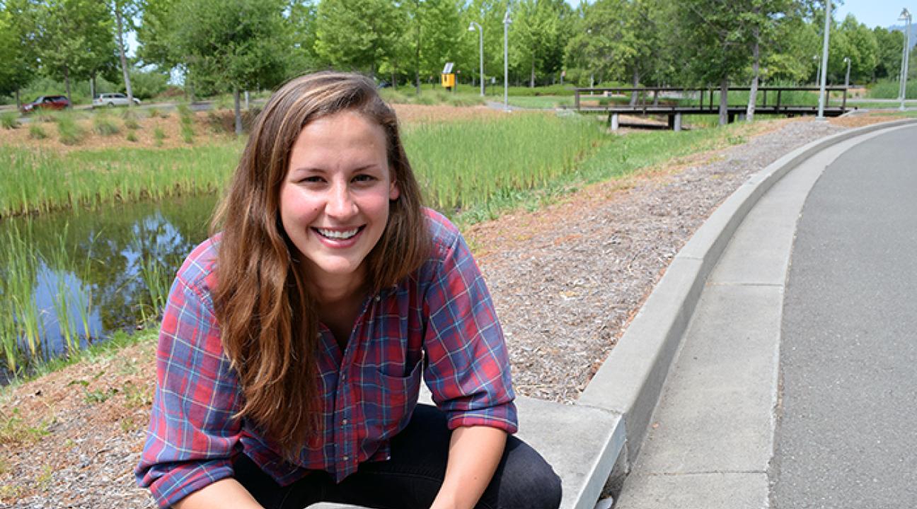  Kara Kelly crouches atop a drain that leads to a manmade wetland at the Green Music Center at Sonoma State. 