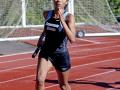 Angelique Lopez running with the baton at a track meet
