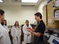 David Bero teaches a group of geology students how to make rocks thin enough for use under a microscope in a recent class