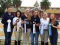 Equestrian team members proudly display their awards. 