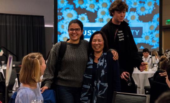 President Sakaki poses with student at the "Presidents Climate Leadership Commitment"